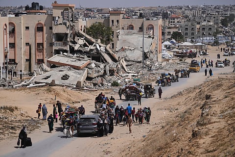 Displaced Palestinians flee from Khan Younis, Gaza, amid the ongoing Israeli military offensive in the area, on Monday, May 19, 2025.