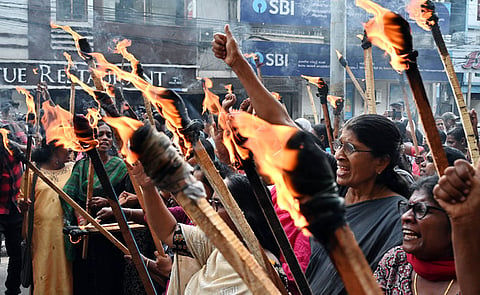 Anganwadi workers hold a torchlight march in front of the Vellore district collectorate on Friday evening, raising some of their long-pending demands, including regularisation and pension benefits.