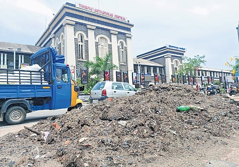 The silt and garbage removed from the stormwater drain at Thampanoor has been lying at the site for days causing inconvenience to the public. A scene in front of the Central Railway Station on Tuesday
