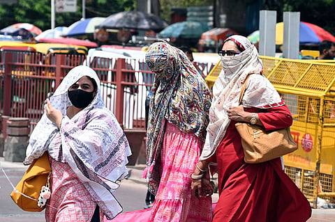 Women cover their faces to protect themselves from the scorching heat in Delhi summers.