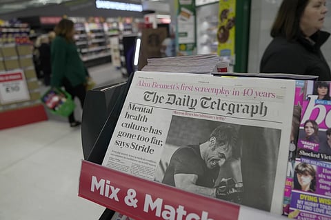 The Daily Telegraph newspaper with the front page of French President Emanuel Macron is seen at a supermarket in London, March 21, 2024.