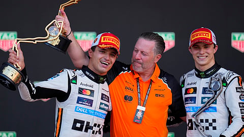 McLaren driver Lando Norris of Britain, left, celebrates on the podium with Zak Brown, McLaren chief, centre, and McLaren driver Oscar Piastri of Australia after winning the Formula One Monaco Grand Prix race at the Monaco racetrack in Monaco, Sunday, May 25, 2025.