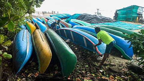 Fishermen place boats away from the shore in view of the rough sea during monsoon season, in Kozhikode, Kerala, Tuesday, May 27, 2025.