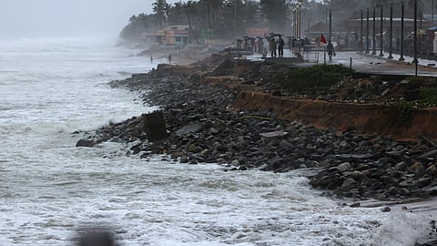 Visitors at Shanghumugham beach in Thiruvananthapuram on Monday, which has suffered damage from sea waves due to the heavy rains that have persisted for the last four days. Additionally, some of the recent renovations made to the beach have also been affected by the adverse weather conditions.