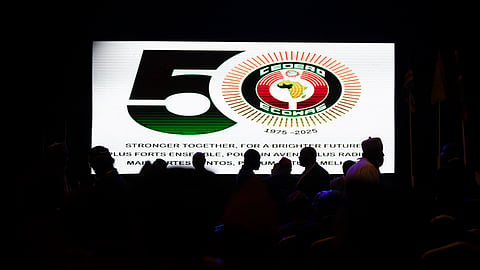 Guests walk past a screen displaying the number '50' during the celebration of the 50th anniversary of the creation of the Economic Community of West African States (ECOWAS) at Eko Hotel in Lagos on May 28, 2025.