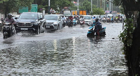Motorists wading through the waterlogged Pettah-Chakkai road due to heavy monsoon rains in Thiruvananthapuram.