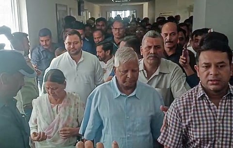 Rashtriya Janata Dal chief Lalu Prasad Yadav, his wife and son Tejashwi Yadav leave the Rouse Avenue Court in Delhi.