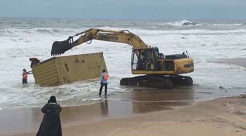 Officials recover a shipping container washed ashore at Vaniyakudi beach, suspected to be from the Kerala-bound Liberian vessel MSC ELSA 3, which sank off the coast of Kochi.