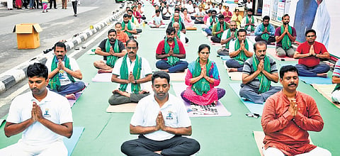NTR Collector Lakshmisha and others perform yoga in Vijayawada