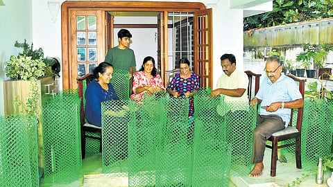 Happiness Circle volunteers prepare sapling guards on Sunday, ahead of the June 5 plantation drive on Container Road.