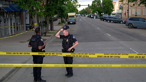 Police officers stand on Pearl street, the site of an attack on demonstrators calling for the release of Israeli hostages held in Gaza, in Boulder, Colorado, on June 1, 2025.