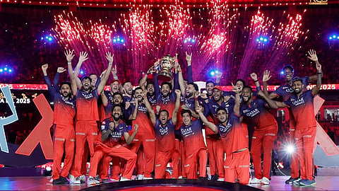 Royal Challengers Bengaluru players holding the trophy.