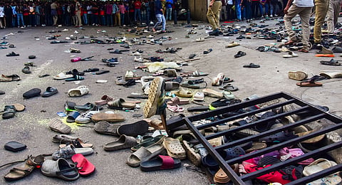 Footwears lie on the ground outside the Chinnaswamy Stadium following a stampede after a large number of fans gathered for the felicitation of IPL 2025 winning Royal Challengers Bengaluru team, in Bengaluru, Karnataka, Wednesday, June 4, 2025.