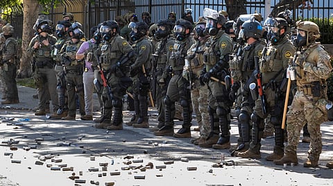 Tear gas canisters are seen on the floor during a protest following federal immigration operations, in the Compton neighborhood of Los Angeles, California early on June 8, 2025