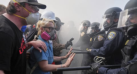 Protesters confront police on the 101 Freeway near the Metropolitan Detention Center of downtown Los Angeles, Sunday, June 8, 2025, following last night's immigration raid protest.