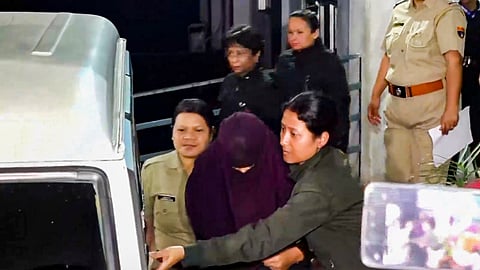 Police escort Sonam Raghuvanshi, accused in the alleged murder of her husband Raja Raghuvanshi during their honeymoon in Meghalaya.