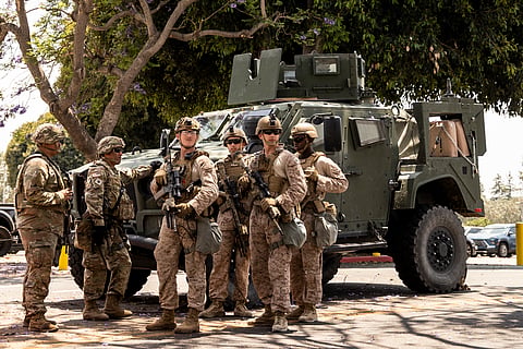 Members of the California National Guard and U.S. Marines, guard the entrance outside the Wilshire Federal Building, ahead of Saturday's nationwide "No Kings Day" protest, in Los Angeles, Calif., Friday, June 13, 2025.