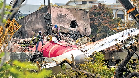 Cranes clearing the debris of the crashed Air India plane in Ahmedabad.