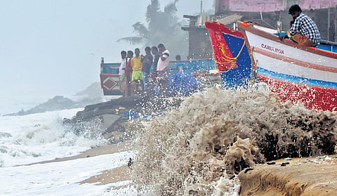 Fishermen at Mampally, near Anchuthengu in Thiruvananthapuram, anxiously observe the churning sea as powerful waves crash onto the shore. With a rain alert in effect, boats remain tied to the docks, leaving the community in misery