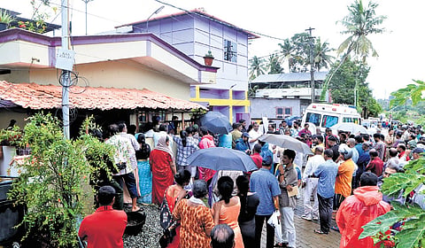 Neighbours and local residents gather outside the couple’s house at Karamana, where they follow the incident