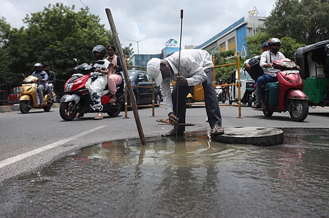 A HMWSSB worker is seen fixing an overflowing water connection near Rail Nilayam in Secunderabad.