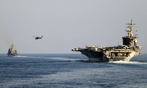 The aircraft carrier USS Dwight D. Eisenhower and other warships crosses the Strait of Hormuz into the Persian Gulf on Sunday, Nov. 26, 2023.
