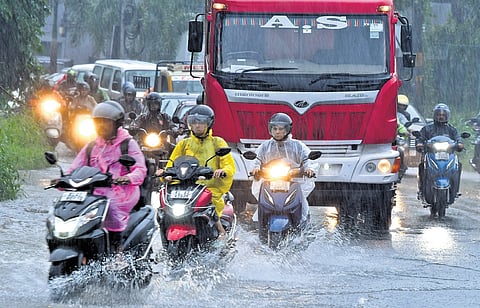 Vehicles navigate a waterlogged road in Kalamassery on Thursday