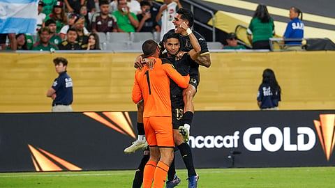 Honduras midfielder Carlos Pineda (19) celebrates scoring the game-winning penalty kick with Honduras goal keeper Edrick Menjivar (1) and Honduras forward Luis Palma (17) after a CONCACAF Gold Cup quarterfinal soccer match against Panama.