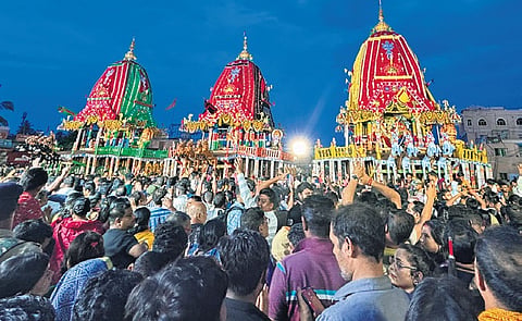 people gather near chariots of Lord Jagannath near Gundicha temple in Puri, on Sunday
