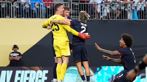 United States goalkeeper Matthew Freese celebrates with teammates after winning a penalty kick shootout of a CONCACAF Gold Cup quarterfinals soccer match against Costa Rica, Sunday, June 29, 2025, in Minneapolis.