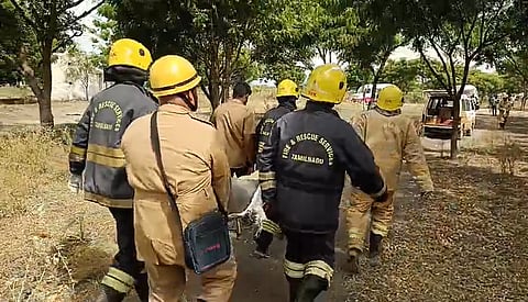 Fire and Rescue Service personnel carrying injured persons to the ambulance.