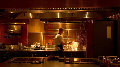 A chef lights charcoal at FZN Restaurant on Palm Jumeirah in Dubai, United Arab Emirates, Friday, June 13, 2025.