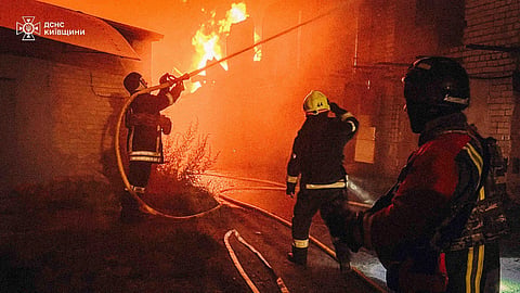 In this photo provided by the Ukrainian Emergency Service, first responders work to extinguish a fire following a Russian attack in the Kyiv region, Ukraine, Friday, July 4, 2025.