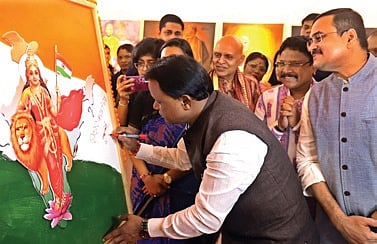 CM Majhi signs on a painting of Bharat Mata on the occasion of Mookerjee’s 125th birth anniversary