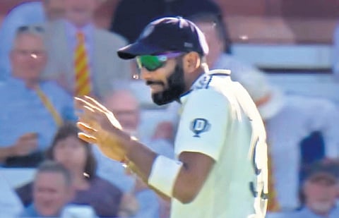 Jasprit Bumrah tries to fend off ladybirds on the first day at Lord’s. He took five wickets on Friday.