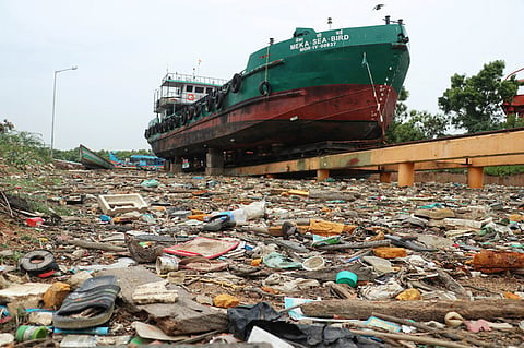 A ship stands grounded amidst a sea of plastic and debris in Puducherry