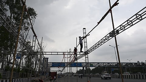 Preparations underway for constructing tented shades for Kanwar yatris returning from Haridwar, at Ghazipur on Thursday in New Delhi.