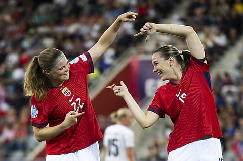 Norway's Signe Gaupset, left, celebrates with her teammate Elisabeth Terland after scoring the opening goal during the Euro 2025 Group A soccer match between Norway and Iceland in Thun, Switzerland, Thursday, July 10, 2025.