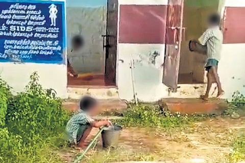 Students cleaning toilets at a primary school in Pudukkottai