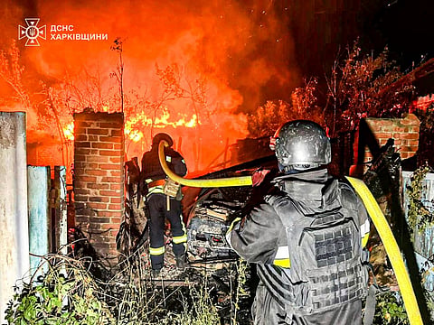 In this photo provided by the Ukrainian Emergency Service, firefighters try to put out a fire following a Russian attack in Kharkiv region, Ukraine, Tuesday, July 15, 2025.