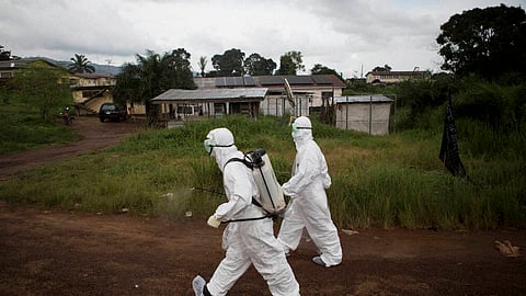 Healthcare workers spray disinfectant to prevent the spread of the Ebola virus in Kenema, Sierra Leone.