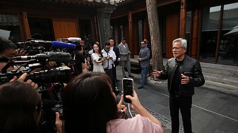 CEO of Nvidia Jensen Huang speaks to journalists during a press conference at the Mandarin Oriental Qianmen after attending the third China International Supply Chain Expo, in Beijing, Wednesday, July 16, 2025.