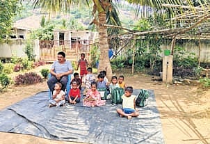Children attend classes in an open-air school