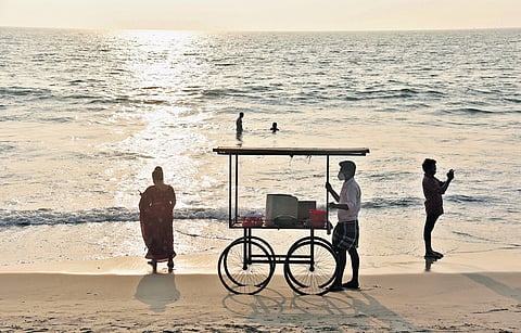 A vendor awaits customers on a beach | Express