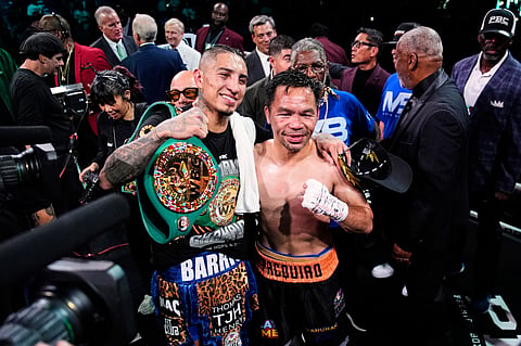 Mario Barrios, left, and Manny Pacquiao one for a photo after fighting to a majority draw in a welterweight title boxing match Saturday, July 19, 2025, in Las Vegas.