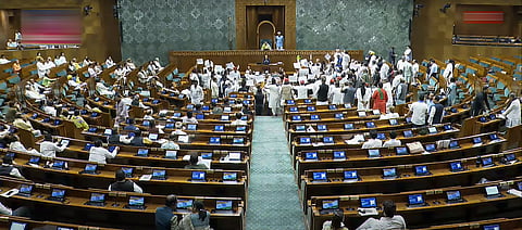 Opposition members protest in the Lok Sabha demanding discussion on the Special Intensive Revision (SIR) of electoral rolls in poll-bound Bihar, during the Monsoon session of Parliament, in New Delhi, Wednesday, July 23, 2025.