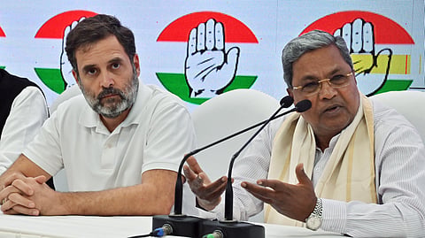 Karnataka Chief Minister Siddaramaiah addresses a press conference with Congress leader Rahul Gandhi at the party headquarters in New Delhi.