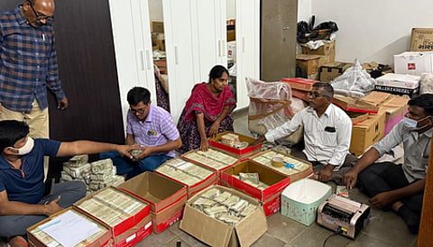 The Special Investigation Team (SIT), probing the alleged multi-crore liquor scam, has seized Rs 11 crore in cash stored in 12 cardboard boxes from a farmhouse in Telangana.