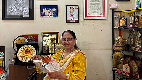 Banu Mushtaq posing with the book Heart Lamp at her residence in Hassan, Karnataka