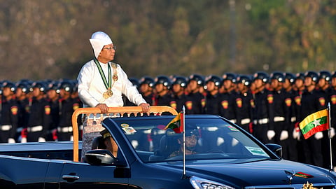 In this photo from January 4, 2023, Myanmar's military chief Min Aung Hlaing stands in a car as he oversees a military display at a parade ground to mark the country's Independence Day in Naypyidaw